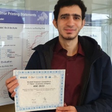 PhD student Islem Bouzeniavor with certificate and in front of his thesis on "Detecting Inconsistencies in If-Condition-Raise Statements".