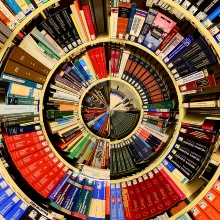 Library shelf completely filled with books, depicted in a circle.